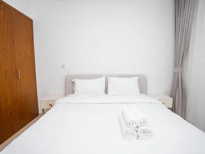 a bedroom with a white bed with two towels on it at Holidays R Us villa 3 bedroom premium location in Dubai