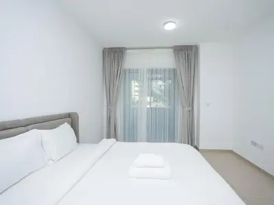 a bedroom with a white bed and a window at Holidays R Us villa 3 bedroom premium location in Dubai