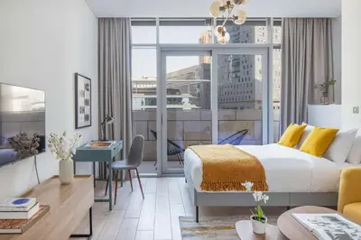 a hotel room with a bed and a large window at Silkhaus modern furnished studio in DIFC center with balcony in Dubai