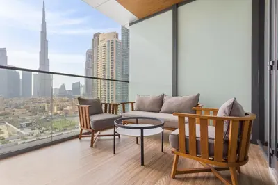 a living room with a couch and chairs on a balcony at Ramee Dream Hotel Downtown in Dubai