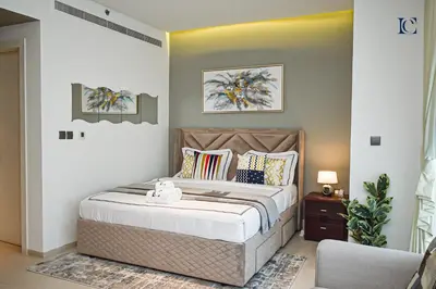 a bedroom with a bed and a chair at Luxury Escapes - Large Studio in the heart of Dubai Marina - West Avenue in Dubai