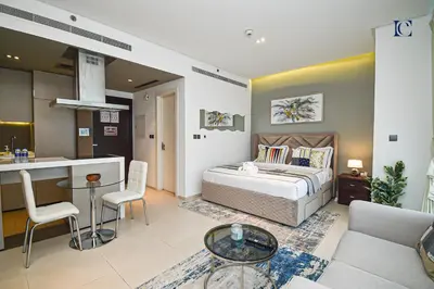 a living room with a bed and a kitchen at Luxury Escapes - Large Studio in the heart of Dubai Marina - West Avenue in Dubai
