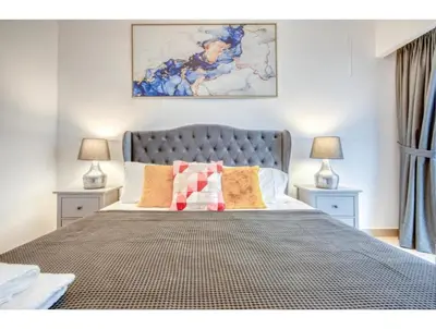 a bedroom with a large bed with two night stands at THE PENTHOUSE near Burj Khalifa and Dubai Mall in Dubai
