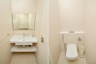 a white bathroom with a sink and a toilet at Luxury Escapes - 1BR Apt with Balcony - West Avenue Marina in Dubai