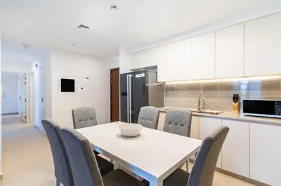 a kitchen and dining room with a table and chairs at GuestReady - The Wandering Oasis in Town Square in Dubai