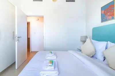 a bedroom with a bed with two plates on it at GuestReady - The Wandering Oasis in Town Square in Dubai