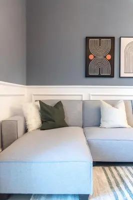 a blue couch with pillows in a living room at GuestReady - The Wandering Oasis in Town Square in Dubai