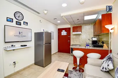 a kitchen with a stainless steel refrigerator in a room at Luxury Escapes - Budget Studio - New Dubai Gate 2 JLT in Dubai