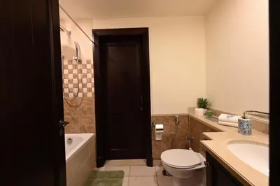 a bathroom with a toilet and a tub and a sink at Newly furnished. Cozy apartment. Quite location. in Dubai