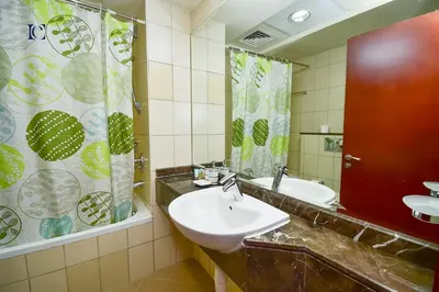 a bathroom with a sink and a mirror at Luxury Escapes - New Lake View Studio in JLT - near Metro in Dubai