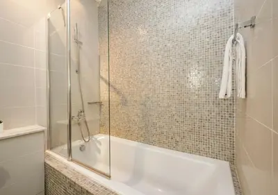 a bathroom with a shower and a bath tub with a glass door at Hometown Apartments - Cosy 1 Br Apartment with Brand New Furniture in DIFC in Dubai