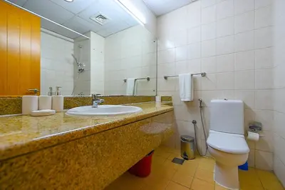a bathroom with a sink and a toilet at Luxury Escapes - Studio near Ibn Battuta Mall & Metro - MOG 193 Discovery Gardens in Dubai