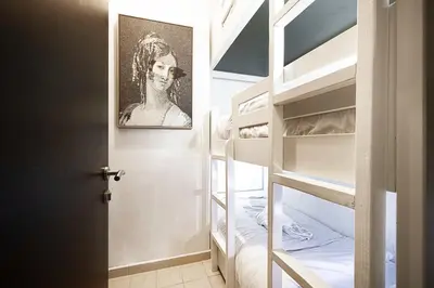 a room with bunk beds with a picture of a woman at Villa with Private Pool & Huge Terrace Overlooking the Marina in Dubai