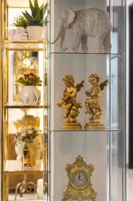 a shelf with figurines and an elephant and a clock at Villa with Private Pool & Huge Terrace Overlooking the Marina in Dubai