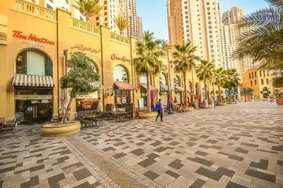 a street in a city with palm trees and buildings at Luxury Apartments in Dubai marina in Dubai