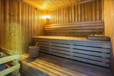 a wooden sauna with a wooden floor and a tub at Luxury Apartments in Dubai marina in Dubai