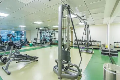 a gym with several treadmills and machines in it at Luxury Apartments in Dubai marina in Dubai