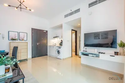 a large white living room with a large tv at Captivating 1BR at DEC Towers Dubai Marina by Deluxe Holiday Homes in Dubai