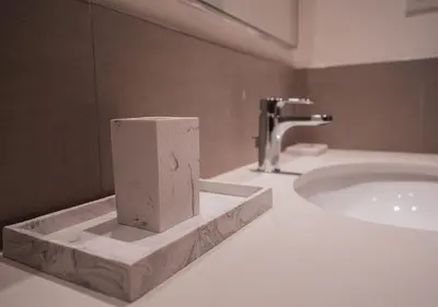 a bathroom sink with a roll of paper towels on it at Nasma Luxury Stays - Elegant Condo With City Views And Dubai Skyline in Dubai