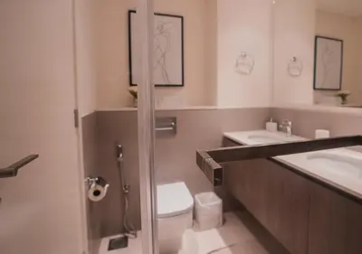 a bathroom with a toilet and a sink at Nasma Luxury Stays - Elegant Condo With City Views And Dubai Skyline in Dubai