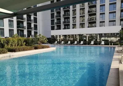a large swimming pool in front of a building at Nasma Luxury Stays - Elegant Condo With City Views And Dubai Skyline in Dubai