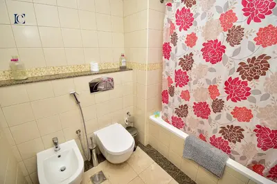a bathroom with a toilet and a shower curtain at Luxury Escapes - 1BR Home with Stunning Marina View - Bay Central Marina in Dubai