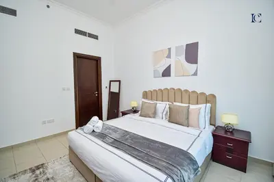 a bedroom with a large bed with white sheets and pillows at Luxury Escapes - 1BR Home with Stunning Marina View - Bay Central Marina in Dubai