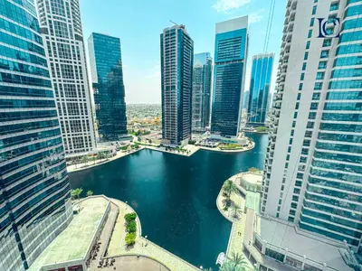 a view of a river in a city with tall buildings at Luxury Escapes - Lake View Brand New Studio in X1 Tower JLT in Dubai