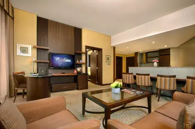 a living room with a couch and a table at TIME Oak Hotel & Suites in Dubai