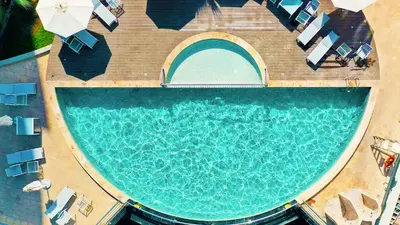 an overhead view of a swimming pool with chairs and a pool at Signature Hotel Apartments and Spa in Dubai
