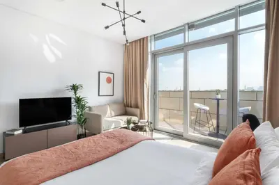 a bedroom with a bed and a large window at Silkhaus modern studio with Burj Khalifa view in DIFC in Dubai