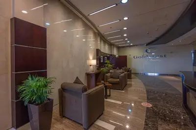 a lobby with couches and plants in a building at HiGuests - Spacious Apartment Close to Dubai Marina Walk in Dubai