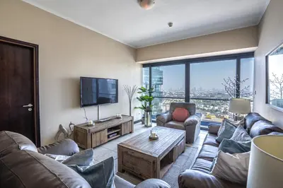 a living room with couches and a flat screen tv at HiGuests - Spacious Apartment Close to Dubai Marina Walk in Dubai