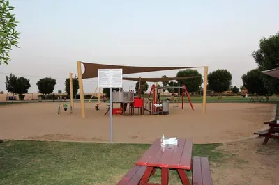 a park with a picnic table and a playground at Upgraded spacious 3BR+Maid Villa in Dubai