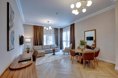 a living room with a couch and a table and chairs at Regency Luxury Suites in Dubai