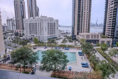 an overhead view of a pool in a city with tall buildings at 3BR Haven with Burj Views by MagnoliasVHR in Dubai