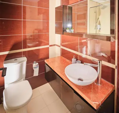 a bathroom with a white toilet and a sink at Wonderful two bed room with full marina view in Dubai