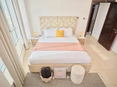 a bedroom with a large bed in a room at Wonderful two bed room with full marina view in Dubai