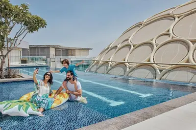 a family on a pool ride at a resort at Rove Expo City in Dubai