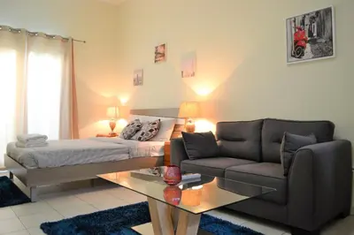 a bedroom with a bed and a couch and a table at Luxury Escapes - Budget-Friendly Studio Near Metro - MED67 DG in Dubai