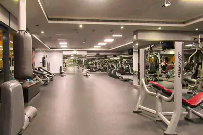 a gym with lots of treadmills and machines at Brand New Studio Apt - Near JLT Metro in Dubai
