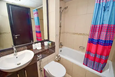 a bathroom with a sink and a toilet and a shower at Brand New Studio Apt - Near JLT Metro in Dubai