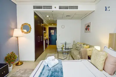 a living room with a bed and a couch at Brand New Studio Apt - Near JLT Metro in Dubai