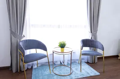 two chairs and a table in front of a window at Apartments on JBR by HAPPY SEASON in Dubai