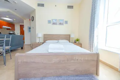 a bedroom with a large bed in a room at Luxury Escapes - Modern Budget studio with balcony in JLT! in Dubai