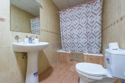 a bathroom with a toilet and a sink at Luxury Escapes - Modern Budget studio with balcony in JLT! in Dubai