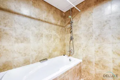 a bathroom with a bath tub in a room at Calm Studio at Sky Gardens DIFC by Deluxe Holiday Homes in Dubai