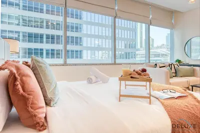 a bedroom with a large bed and a couch at Radiant Studio at Sky Gardens DIFC by Deluxe Holiday Homes in Dubai
