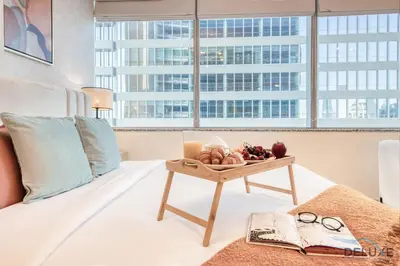 a tray of fruit on a bed in a room with a window at Radiant Studio at Sky Gardens DIFC by Deluxe Holiday Homes in Dubai