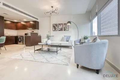 a living room with a couch and a table at Gorgeous 1BR at Sky Gardens, DIFC by Deluxe Holiday Homes in Dubai